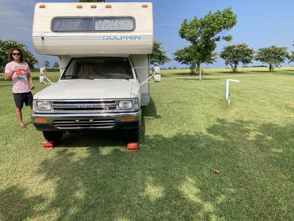 my friend sam standing in front of our RV